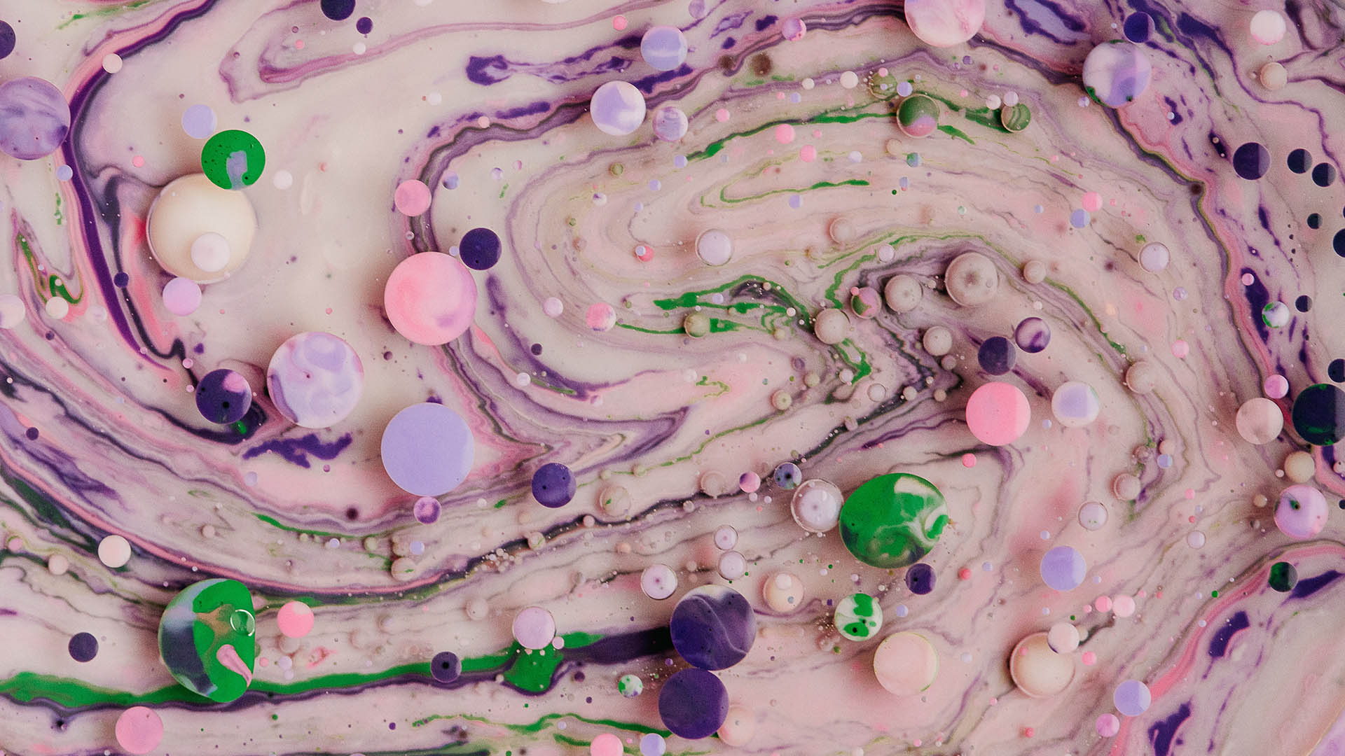 Colorful bubbles on the surface of unmixed paints - pink, light green, beige, lilac. Unmixed paints resemble the surface of marble.