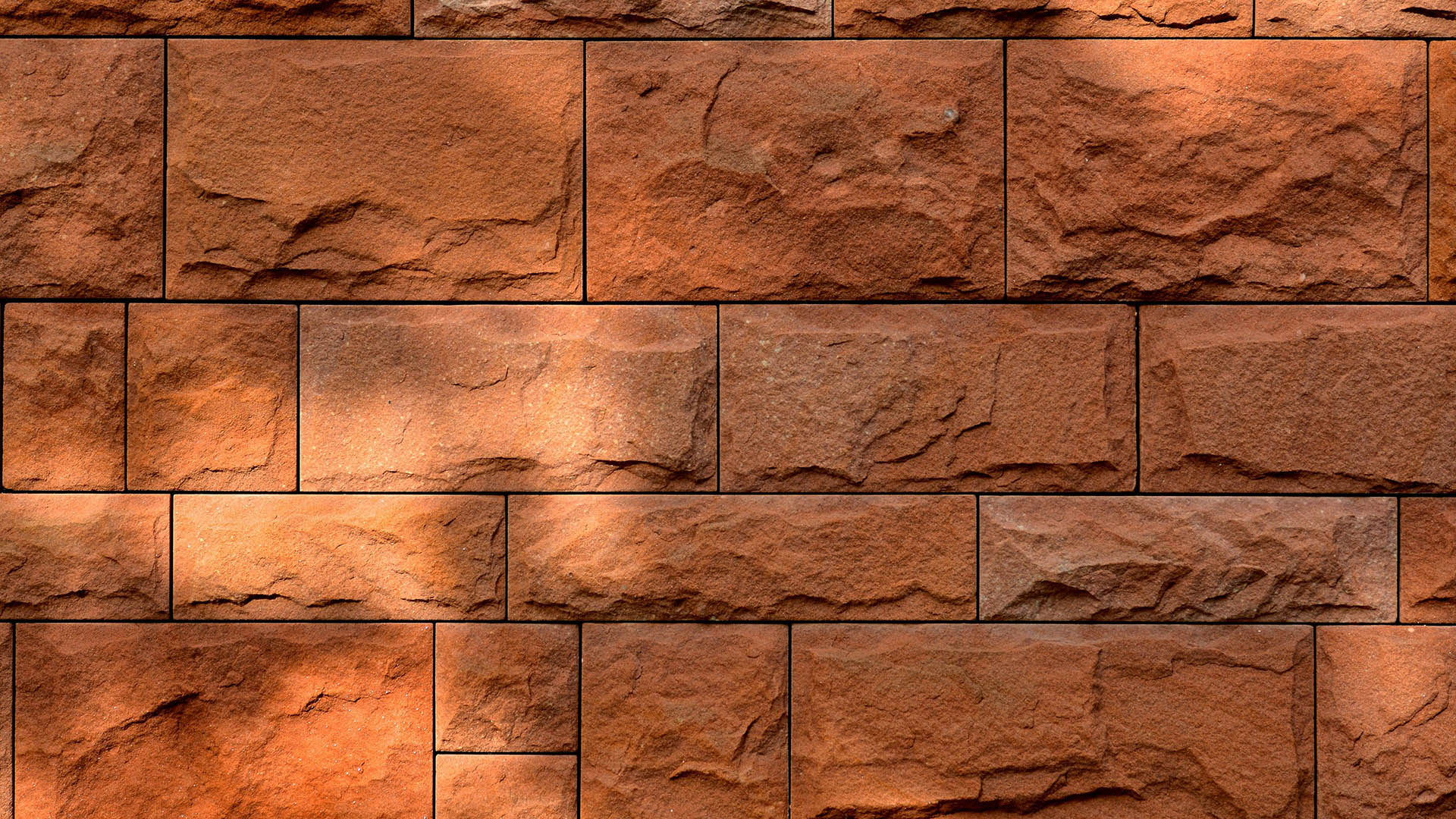 Part of the wall is decorated with square and rectangular tiles of different sizes. Tiles cut from andesite slate of ginger color. The surface of the tile resembles torn stone.